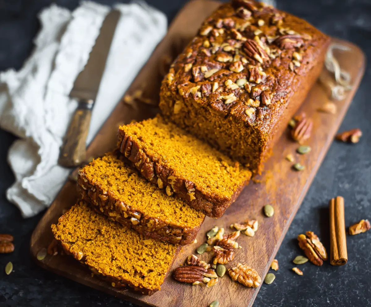 Delicious homemade vegan pumpkin bread sliced and ready to serve, featuring a moist texture and warm autumn spices.