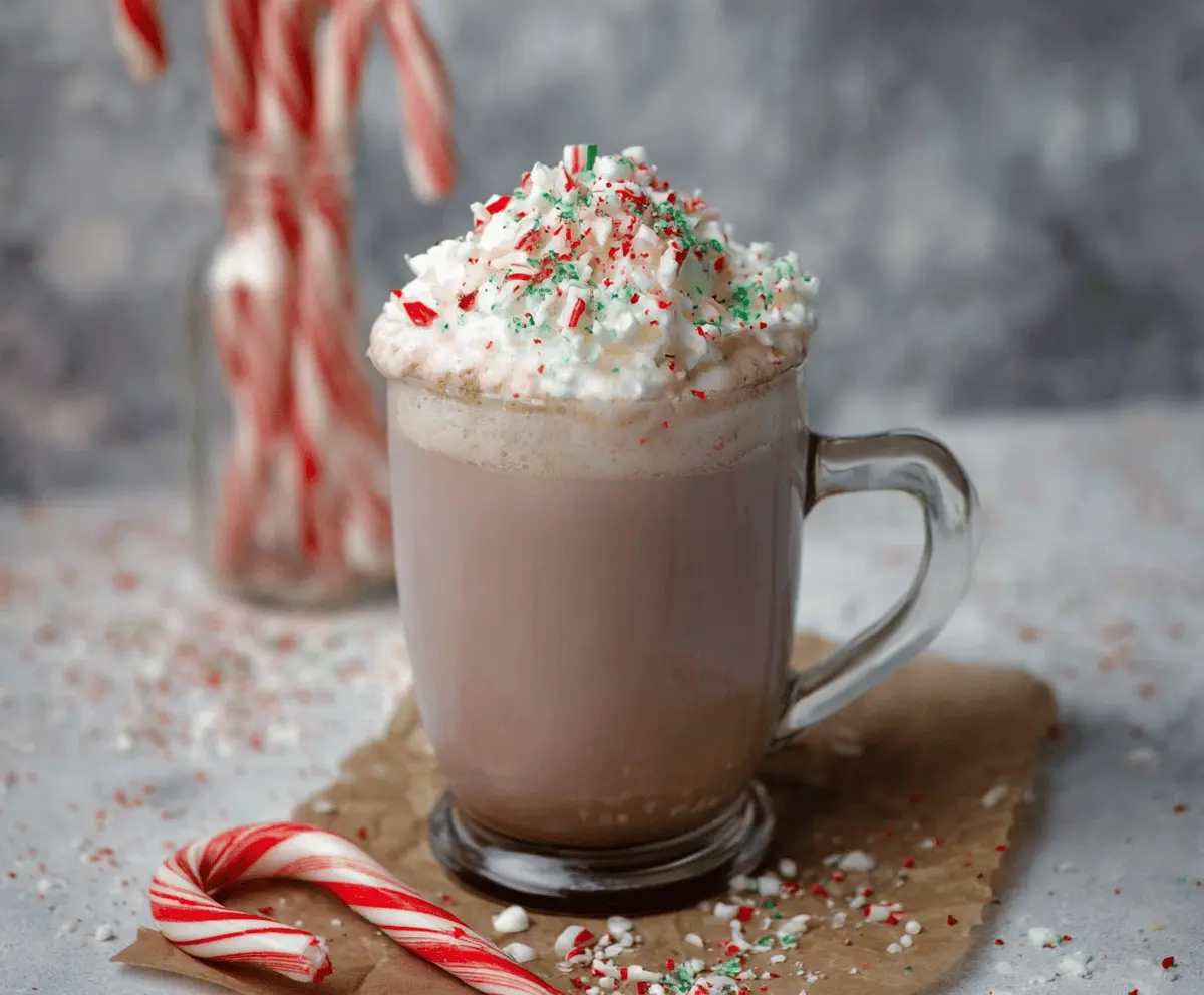 Creamy Candy Cane Hot Chocolate garnished with whipped cream and peppermint candies
