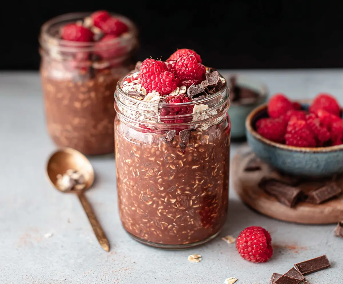 Delicious chocolate raspberry overnight oats in a glass jar, perfect for a healthy breakfast.