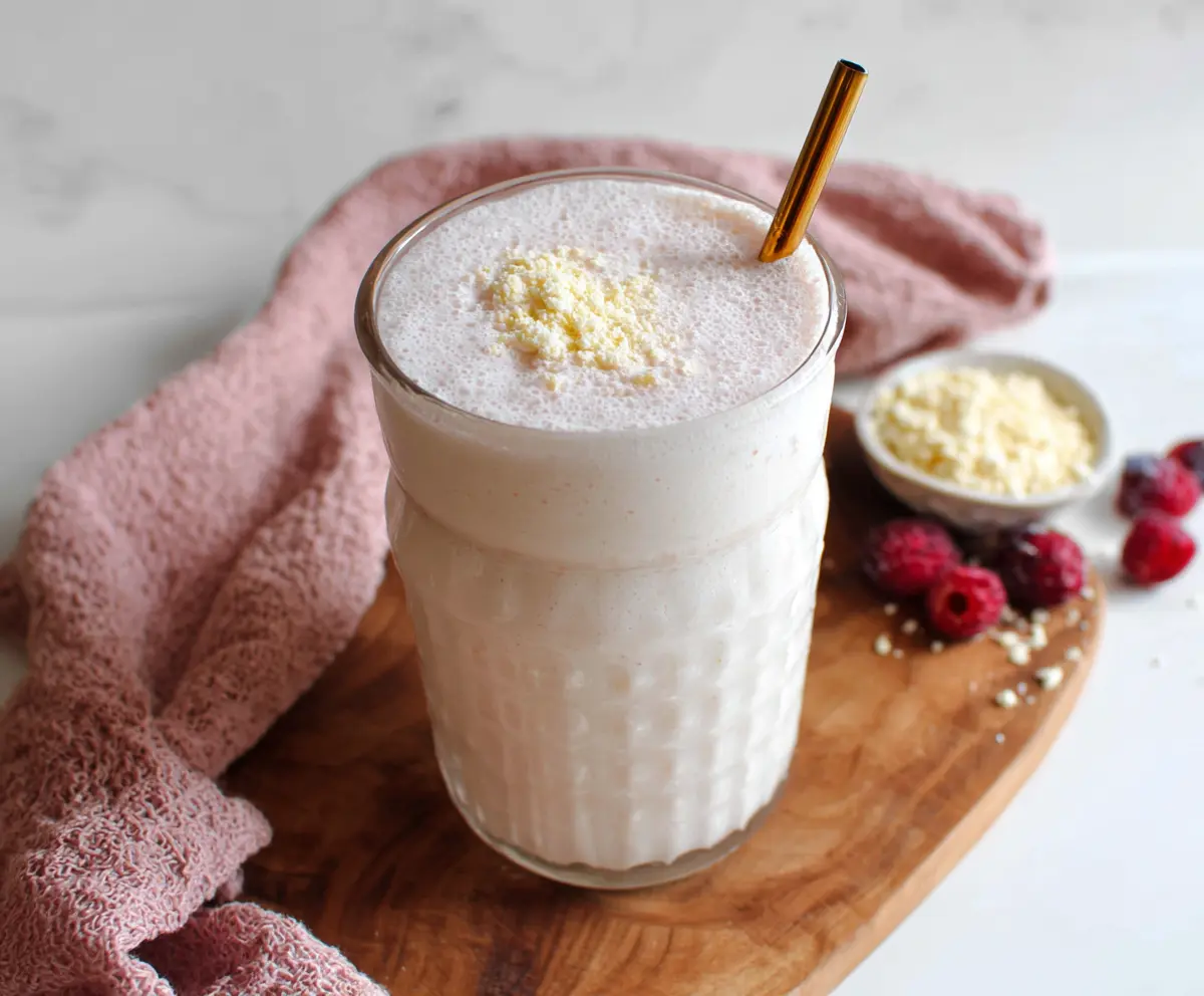 Healthy cottage cheese protein shake in a glass mug with fresh fruit garnish.