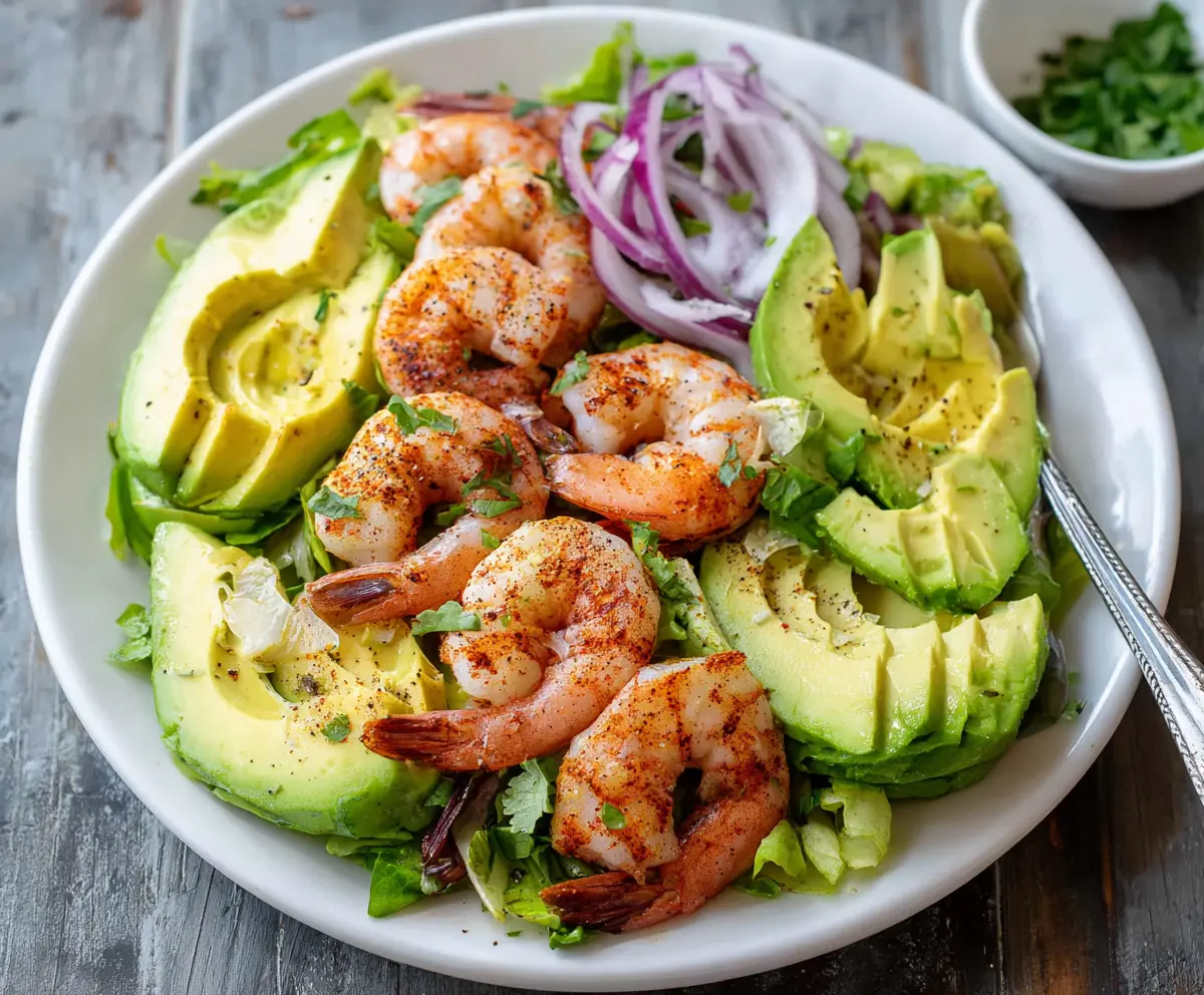 Fresh shrimp and creamy avocado salad served in a bowl, perfect for a healthy meal.