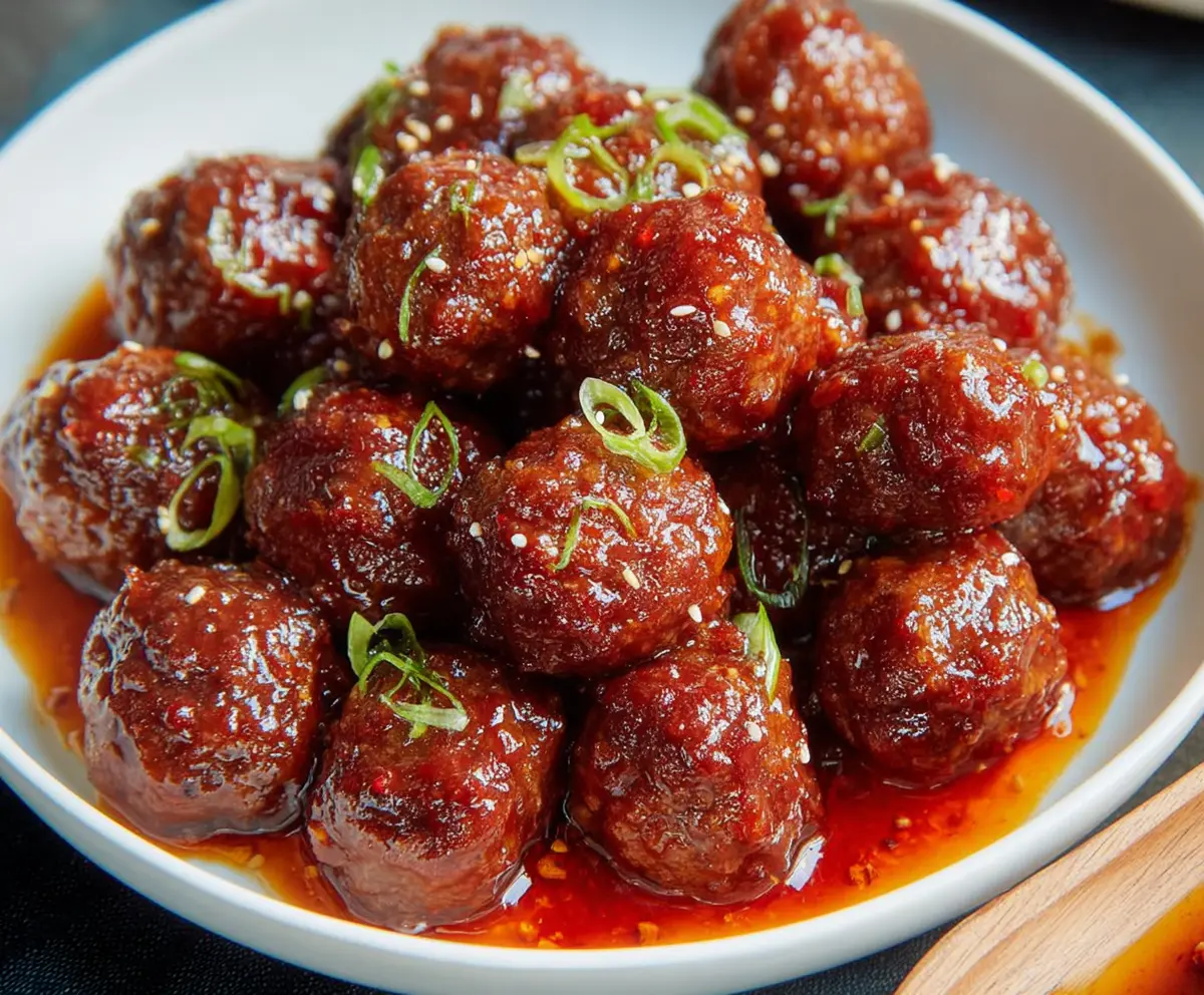 Delicious sweet and spicy meatballs served on a platter, perfect for appetizer or party snack.