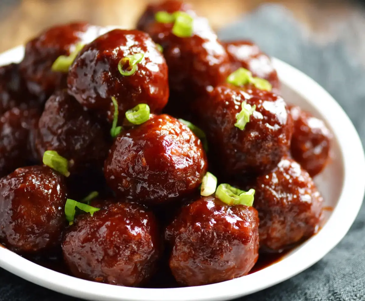 Delicious 3 Ingredient Crockpot BBQ Meatballs ready to serve in a slow cooker.