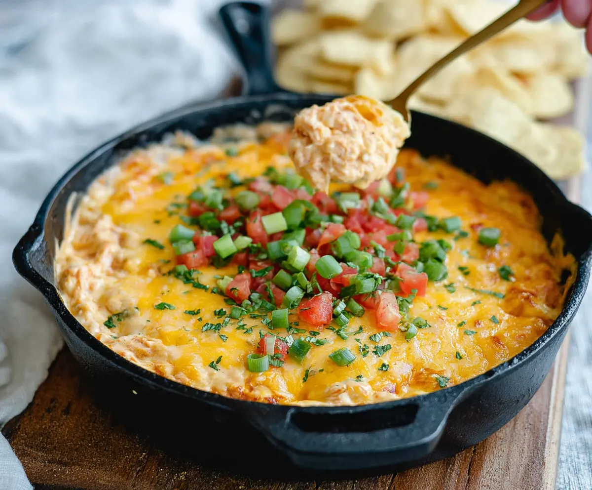 Cream Cheese Rotel Dip with melted cheese and tomatoes in a bowl, perfect for parties.