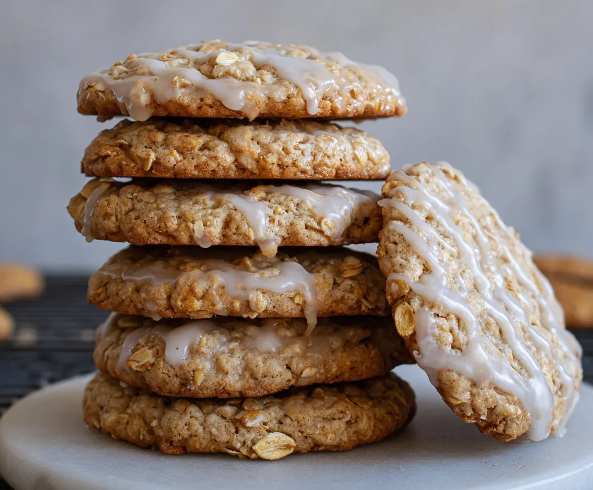 Delicious sourdough discard glazed oatmeal cookies on a plate, showcasing a golden-brown crust and sweet glaze.