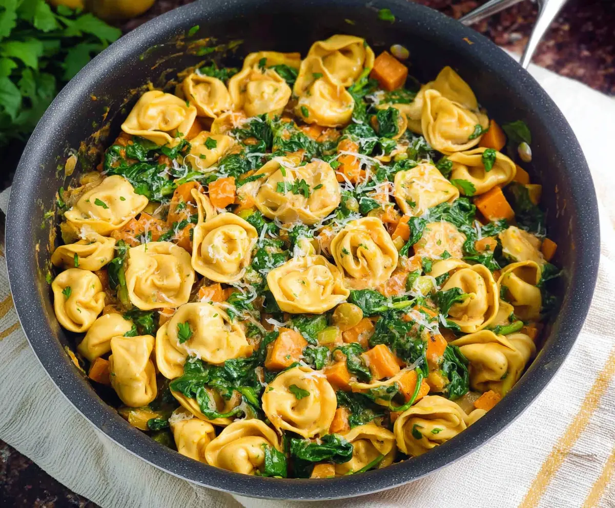 Delicious skillet tortellini with sweet potato and spinach, showcasing a colorful and healthy meal.