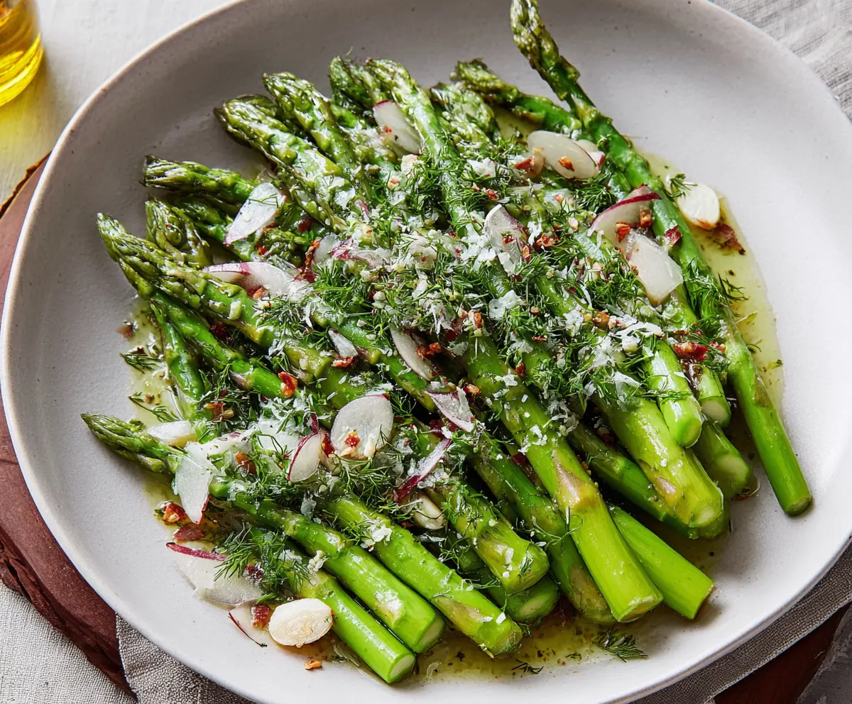 Fresh Italian asparagus salad with cherry tomatoes and balsamic glaze in a rustic bowl.